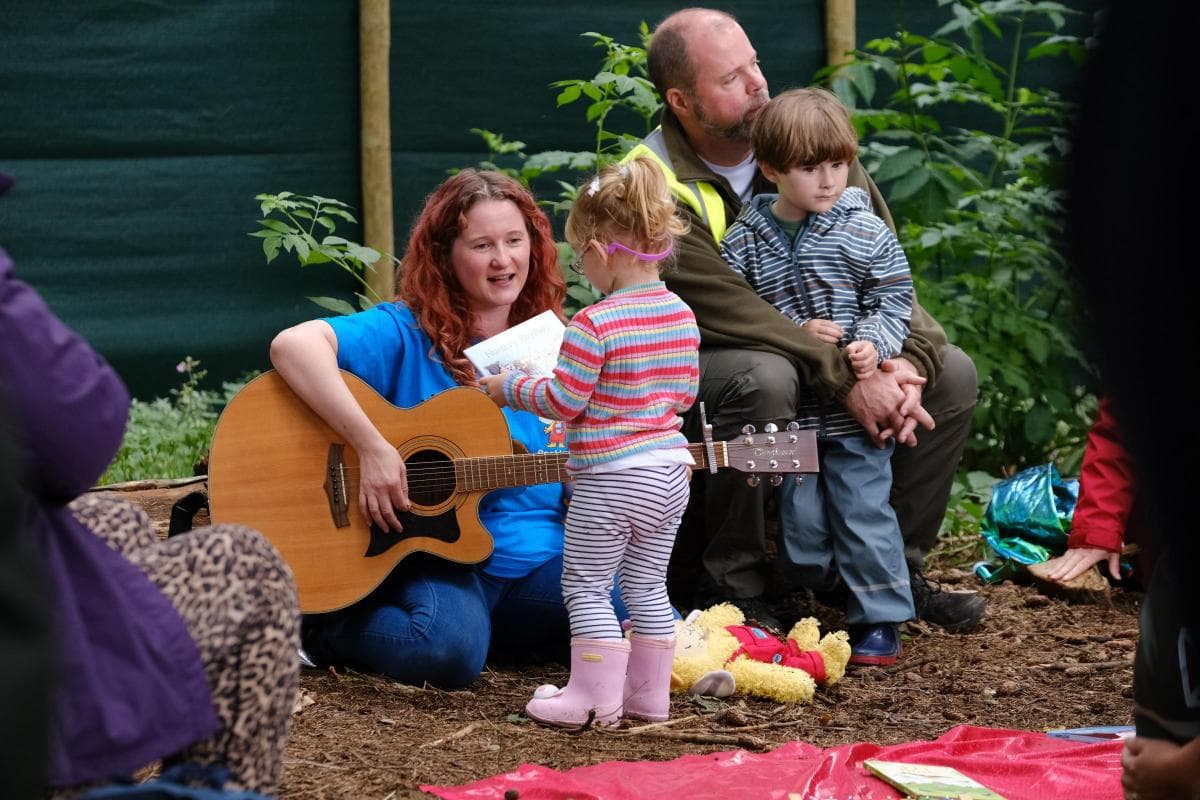 Founder, Louise with a child playing in the mud.